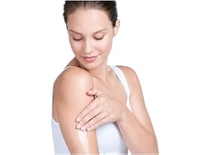  Woman applying lotion to arm, eyes closed, serene expression.