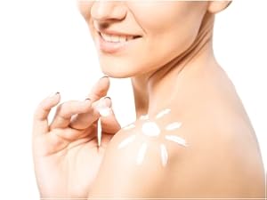 Sunscreen lotion shaped like a sun on woman's shoulder.