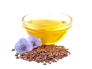 Bowl of flaxseed oil with seeds and blue flowers.