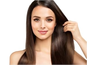 Woman with shiny, healthy hair smiling and touching her hair.